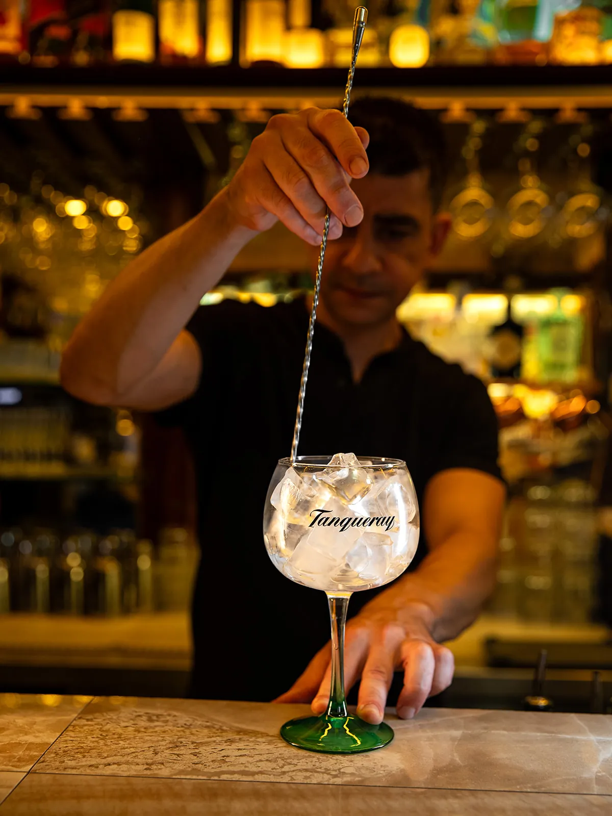 A gin and tonic being made at the bar