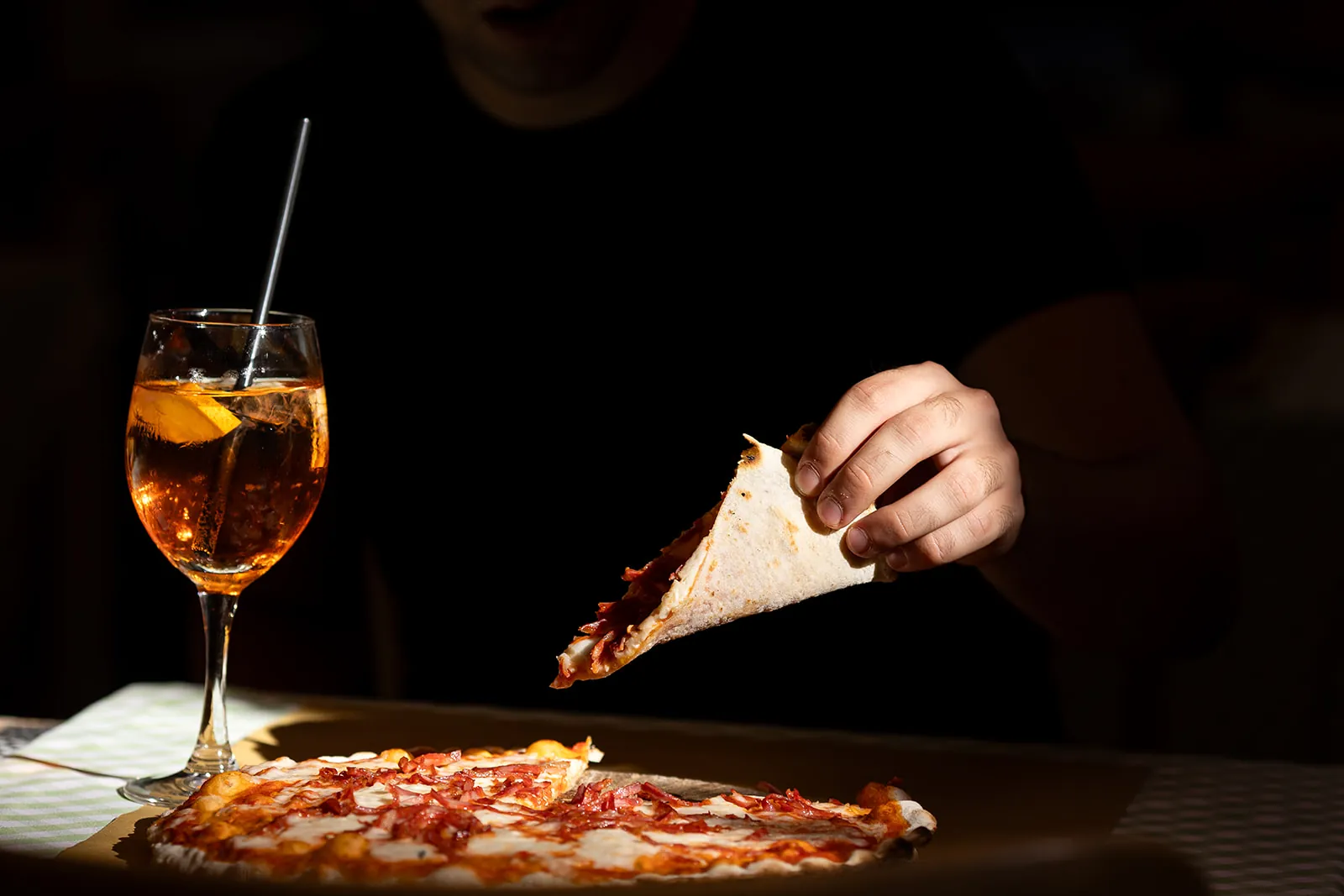 A slice of pizza and a spritz