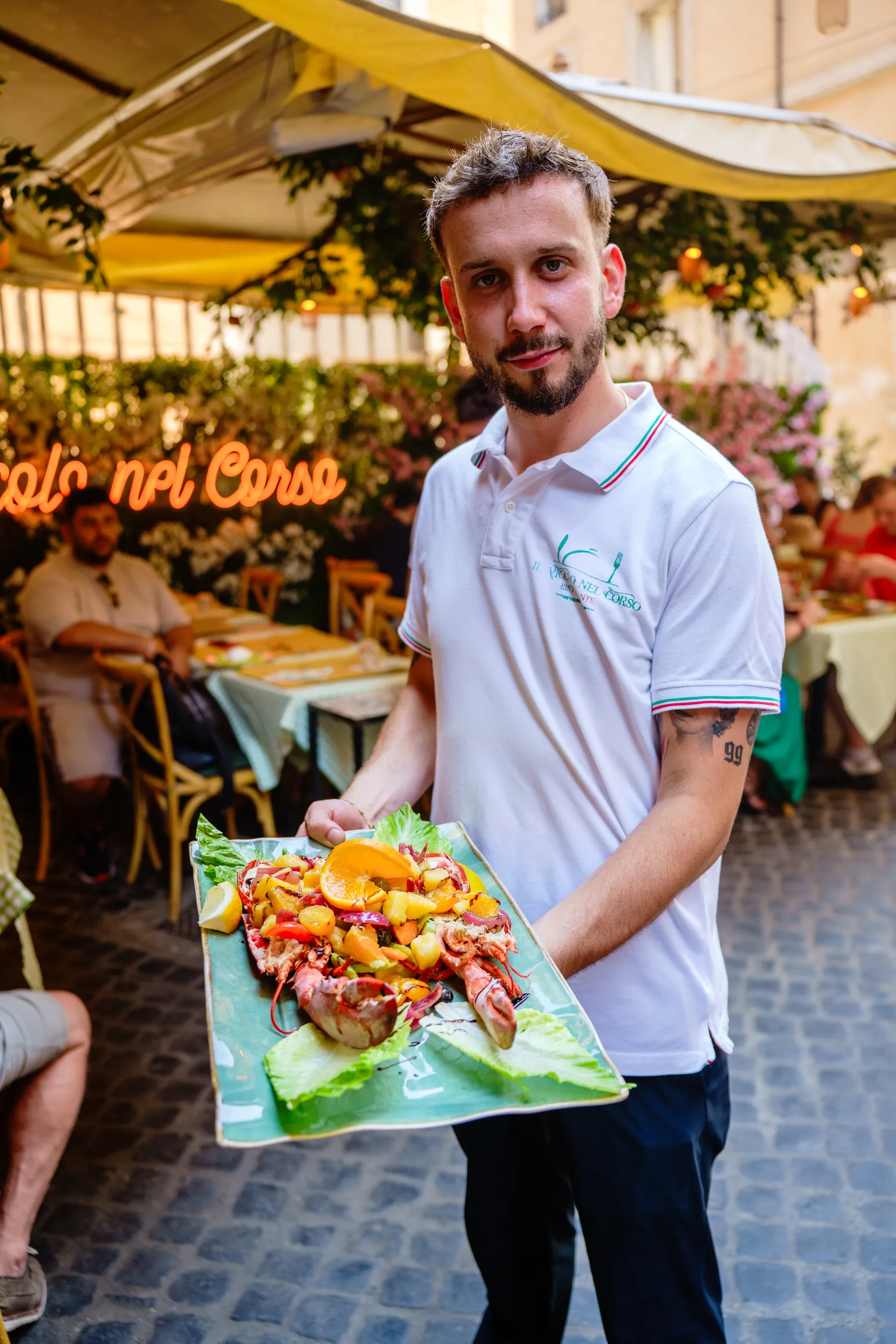 A waiter presenting a fish dish